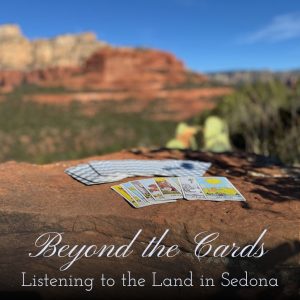 Tarot cards resting on Sedona’s red rocks beneath a bright blue sky, symbolizing the connection between tarot, nature, and spiritual awareness.