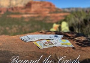 Tarot cards resting on Sedona’s red rocks beneath a bright blue sky, symbolizing the connection between tarot, nature, and spiritual awareness.
