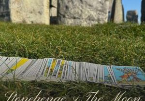 Image of tarot cards fanned out in front of stones at Stonehenge
